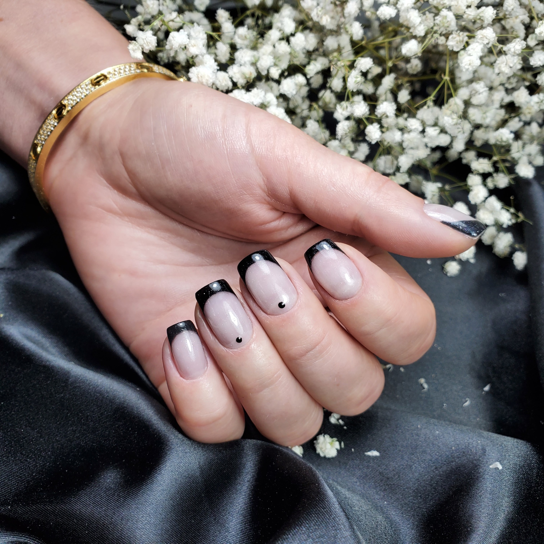 Milky nude manicure with classic black French tips